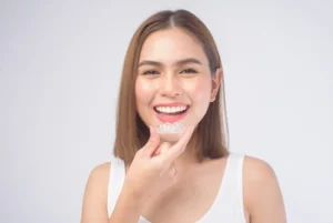 woman showing how to wear invisalign aligners